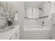 Stylish bathroom featuring white subway tile, a soaking tub, and a modern vanity at 7100 W Ellsworth Pl, Lakewood, CO 80226