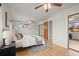 Cozy bedroom featuring hardwood floors, ceiling fan, and closet at 7100 W Ellsworth Pl, Lakewood, CO 80226