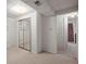 Bedroom featuring closet with mirrored doors and an open entrance to another room at 7100 W Ellsworth Pl, Lakewood, CO 80226