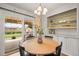 Bright dining area with chandelier, built-in cabinets, and sliding glass doors leading to backyard and patio at 7100 W Ellsworth Pl, Lakewood, CO 80226