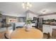 Cozy dining area flowing into the kitchen featuring stainless steel appliances and a kitchen island with wood countertop at 7100 W Ellsworth Pl, Lakewood, CO 80226