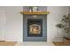 Close-up of the stylish fireplace with gray tile surround and wooden mantel, perfect for cozy evenings at 7100 W Ellsworth Pl, Lakewood, CO 80226