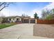 Well-maintained home featuring a two-car garage, landscaped front yard, and a welcoming entrance at 7100 W Ellsworth Pl, Lakewood, CO 80226