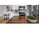 Bright kitchen featuring stainless steel appliances, white cabinets, subway tile backsplash, and wooden island at 7100 W Ellsworth Pl, Lakewood, CO 80226