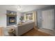 Inviting living room with a cozy fireplace, hardwood floors, and a large window providing natural light at 7100 W Ellsworth Pl, Lakewood, CO 80226
