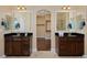 Dual vanity sinks open to spacious walk-in closet and glass shower at 8171 E 33Rd Ave, Denver, CO 80238