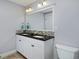 Well-lit bathroom with double vanity, modern fixtures, and a tile shower at 8171 E 33Rd Ave, Denver, CO 80238