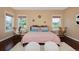This bedroom features sunburst decor, a plush rug, and hardwood floors at 8171 E 33Rd Ave, Denver, CO 80238