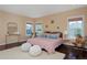 Bright bedroom with natural light, hardwood floors, and a plush rug at 8171 E 33Rd Ave, Denver, CO 80238
