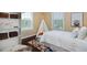 Cozy bedroom featuring a window, shelves, and a custom teepee at 8171 E 33Rd Ave, Denver, CO 80238