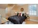 Comfortable bedroom featuring a queen bed, modern lighting, and natural light from a window at 8171 E 33Rd Ave, Denver, CO 80238