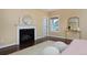 Relaxing bedroom with fireplace, hardwood floors, and soft decor at 8171 E 33Rd Ave, Denver, CO 80238