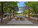 A long, wooden table and benches sit beneath a pergola, providing a shady and inviting outdoor space for gatherings at 8171 E 33Rd Ave, Denver, CO 80238