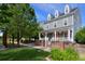 Charming two-story home boasts a classic gray exterior, inviting front porch, manicured lawn, and well-kept landscaping at 8171 E 33Rd Ave, Denver, CO 80238