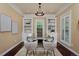 Bright, stylish home office features built-in bookshelves, modern decor, a glass-top desk, and ample natural light at 8171 E 33Rd Ave, Denver, CO 80238