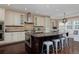 A sun-filled kitchen displays a large island, stainless appliances, and a cozy breakfast nook at 8171 E 33Rd Ave, Denver, CO 80238