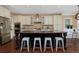 Large kitchen island with seating complements stainless appliances, and custom cabinetry at 8171 E 33Rd Ave, Denver, CO 80238