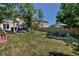 Spacious backyard with a lush lawn, mature trees, and a cozy patio area perfect for outdoor entertaining at 10609 Abilene St, Commerce City, CO 80022