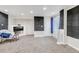 Spacious basement featuring modern brick accents, neutral carpet, and a comfortable seating area at 10609 Abilene St, Commerce City, CO 80022