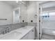 Bathroom featuring double sinks, subway tile backsplash, and a glass-enclosed shower at 10609 Abilene St, Commerce City, CO 80022