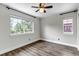 Light bedroom with wood-look floors, large windows, and neutral paint at 10609 Abilene St, Commerce City, CO 80022