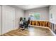 Bright bedroom with wood accent wall, modern gaming setup, and natural light at 10609 Abilene St, Commerce City, CO 80022