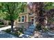 Charming two-story home with brick accents, an American flag, and stone landscaping at 10609 Abilene St, Commerce City, CO 80022