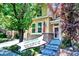 Charming two-story home featuring a brick foundation, inviting front porch, and well-manicured landscaping at 10609 Abilene St, Commerce City, CO 80022