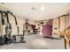 Finished basement area with plush carpeting, a workout station, and sitting area with ornate chairs and a built in cabinet at 6072 Pierson Ct, Arvada, CO 80004