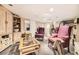 Finished basement area with plush carpeting, two ornate chairs, a glass coffee table and built in cabinet at 6072 Pierson Ct, Arvada, CO 80004