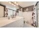 Bright bathroom with tile floors, a large vanity, and a glass-enclosed shower at 6072 Pierson Ct, Arvada, CO 80004