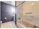 Full bathroom with updated fixtures, a shower-tub combo, and patterned wallpaper at 6072 Pierson Ct, Arvada, CO 80004