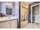 Bathroom with vanity, tub-shower combo, and patterned wallpaper at 6072 Pierson Ct, Arvada, CO 80004