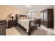 Comfortable bedroom featuring neutral decor, a large bed, and ample closet space at 6072 Pierson Ct, Arvada, CO 80004