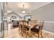 Cozy dining area with hardwood floors that leads to a comfortable living room at 6072 Pierson Ct, Arvada, CO 80004