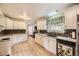Spacious kitchen with plenty of cabinets, countertop space, and hardwood floors at 6072 Pierson Ct, Arvada, CO 80004