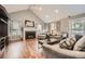 View of an open living room with a fireplace, vaulted ceilings, and wood floors at 6072 Pierson Ct, Arvada, CO 80004