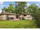 Mature trees abound in a spacious back yard with a wooden deck in an idyllic outdoor setting at 3298 S Krameria St, Denver, CO 80222