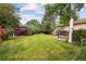 A large back yard is made complete with a beautiful green lawn, mature trees, and a decorative fence at 3298 S Krameria St, Denver, CO 80222