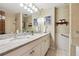 Well-lit bathroom boasts a large double sink vanity, decorative mirror, and tiled walls at 3298 S Krameria St, Denver, CO 80222