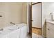 Accessible bathroom featuring a walk-in bathtub, tiled floor and walls, and a grab bar at 3298 S Krameria St, Denver, CO 80222