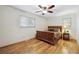 Comfortable bedroom with wood floors, window light, and a classic-style bed with matching nightstand at 3298 S Krameria St, Denver, CO 80222
