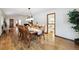 Inviting dining space with seating for ten, hardwood floors and views to kitchen and living room at 3298 S Krameria St, Denver, CO 80222