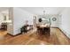 Light-filled dining room with hardwood floors, chandelier and an adjacent view of the kitchen at 3298 S Krameria St, Denver, CO 80222