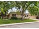 Traditional home exterior featuring a green lawn, mature trees, and an attached two car garage at 3298 S Krameria St, Denver, CO 80222