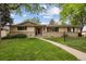 Charming single-story home with manicured lawn, mature trees, and welcoming front porch at 3298 S Krameria St, Denver, CO 80222