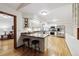 Bright kitchen features white cabinets, granite countertops, stainless steel appliances, and breakfast bar at 3298 S Krameria St, Denver, CO 80222