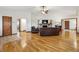 Open-concept living room featuring hardwood floors and a brick fireplace at 3298 S Krameria St, Denver, CO 80222