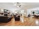 Open concept living room features a brick fireplace, hardwood floors, and lots of natural light at 3298 S Krameria St, Denver, CO 80222