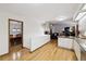 Open-concept living area seamlessly connects kitchen and dining with a cozy fireplace and hardwood floors at 3298 S Krameria St, Denver, CO 80222